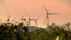 Modern wind-powered turbines rotate in the Honduran countryside Stock Footage