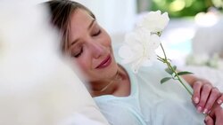 Woman holding and smelling white roses Stock Footage