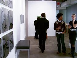 People looking at artwork at gallery opening Stock Footage