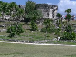 Tulum tourists walk Mayan ruins from a distance Stock Footage