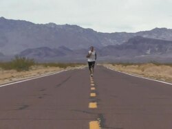 Male running along road Stock Footage