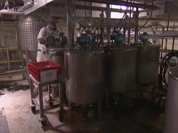 Candy factory worker loading machinery Stock Footage