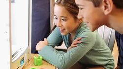 Hispanic elementary age girl and Hispanic preteen boy watch as object prints out on 3D printer Stock Footage