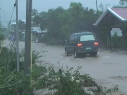 Driving through extreme flood flowing through village, Philippines, typhoon Parma 4th October 2009 Stock Footage