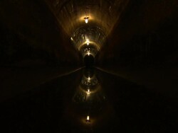 The lights of a sewage tunnel shine over sewage in New York City. Stock Footage