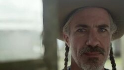 Western store owner stares into camera in Texas ghost town Stock Footage