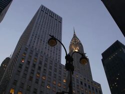 Chrysler Building stacked between apartment buildings at dusk. An old street lamp is featured. Stock Footage