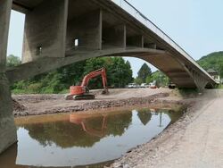 WS View of excavator running at bridge construction site preparing demolition of old bridge Saar river / Wiltingen, Rhineland Palatinate, Germany Stock Footage