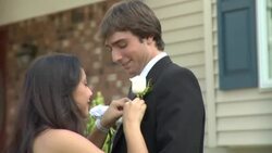CU, Teenage girl (16-17) pining flowers to her prom date's jacket in front of house, Edison, New Jersey, USA Stock Footage