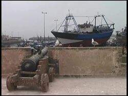 Castle Cannon Aimed At Fishing Boat Stock Footage