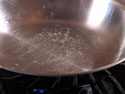 Peppers Sauteing in Butter over a Gas Range Stock Footage