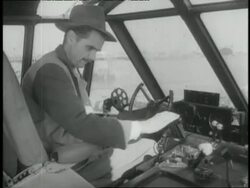 Aviator Howard Hughes sits in the cockpit of the Spruce Goose seaplane. News Clip