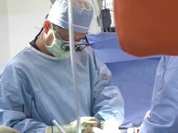 Doctors in operating room performing surgery Stock Footage