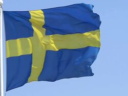 MS SLO MO Shot of Sweden flag waving in wind / Caen, Normandy, France Stock Footage