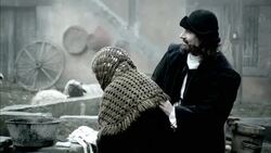Nostradamus examines a village woman for illness and rubs her back. Stock Footage