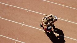 Male runners celebrating on track Stock Footage