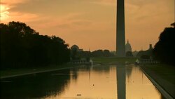 The Washington Monument reflecting in pool with fountains and trees at sunset Stock Footage