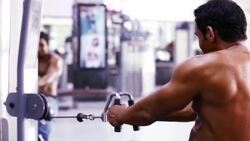 Body Builder Performing Middle Back Exercise in the Gym Stock Footage