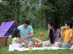 Family drinking juice in a forest, Malshej Ghat, Maharashtra, India Stock Footage