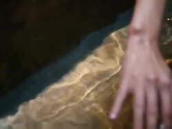 CU Young woman playing with water in bath tub Stock Footage