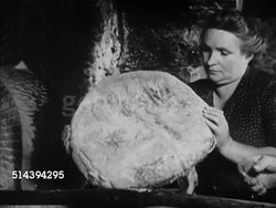 1950: BEAULIEU: DORDOGNE VALLEY:  VS Elderly female walking w/ basket through village street, bakers baking bread in large brick oven, pulling loaves out, dusting them off, putting them out for customers, females taking loaf of bread. France, country Instructional Video