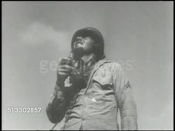1942: JAPANESE AIR FORCES: AERIAL WS Guadalcanal Island coastline. LA TU US Corporal soldier w/ radio looking up. AERIAL WS Unidentified aircraft in flight, possibly bombers. WS (POV Aircraft) PAN Japanese planes in single line flight. WWII, World War II Instructional Video