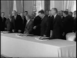 B/W 1963 Dean Rusk, Andrei Gromyko + Lord Hume sitting at table to sign Atomic Test Ban Treaty Stock Footage