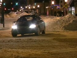 Snowstorm. Winter traffic. Cars on slippery road. Snowfall, snowflakes. Stock Footage