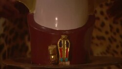 A man wearing a leopard skin robe picks up a crown. Stock Footage