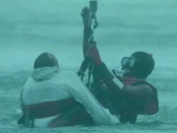 CU AERIAL Shot of two men being airlifted out of sea / Cape Town, Western Cape, South Africa Stock Footage