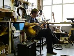 Craftsman 'Luthier' Nigel Forster making hand made Guitars Stock Footage