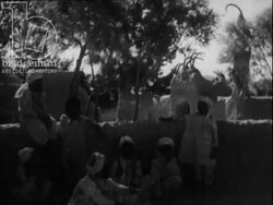 Afghanistan 1945 - nomadic people with camels and donkeys, playing the rubab (traditional Afghan instrument), girl sings. Stock Footage