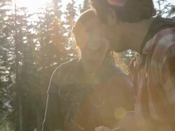 Young couple playing ukulele outdoors Stock Footage