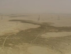 WS AERIAL View of electricity poles at desert with city / Qatar Stock Footage