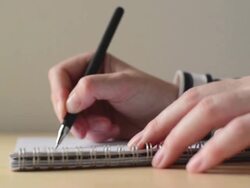 Woman writing notes in textbook Stock Footage