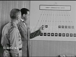 1951: EMERGENCY PREPAREDNESS: DRAMATIZATION: 'City official' showing 'Colonel' chart of emergency services & mobile markers, introducing 'Jack' head console operator to 'Colonel'. Civil Defense Plan, The Red Scare, McCarthyism. Instructional Video