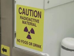 Medium pan-left tilt-down-Caution signs warn of radioactive material. Stock Footage