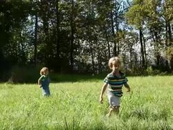 Young brothers running in a field Stock Footage