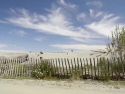 Pan Shot of Wooden fence protecting sand dune in Nature preserve / Aleria, Corsica, France Stock Footage