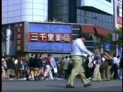 MS Pedestrians crossing road, right to left and left to right, 1 man walks across road to camera, Shibuya, Tokyo, Japan Stock Footage