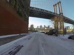 MS POV Shot of Car mountdriving on snow covering street with Brooklyn Bridge / Brooklyn, New York, United States Stock Footage