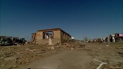 Debris from a tornado lies along a country road. Stock Footage