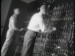 Men flip levers inside the Hoover Dam control room. News Clip