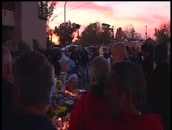 Dozens gathered at Rep. Gabrielle Giffords Tucson office Sunday night to remember the victims of Saturday's shooting. Many lit candles and brought flowers to remember the 20 people shot. Instructional Video