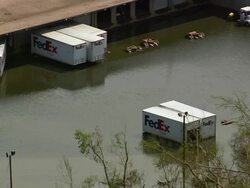 Aerial Fed Ex trucks sitting in flood waters outside depot / Louisiana Stock Footage