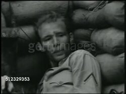 1941: U.S. MARINE BASE: UNDER ATTACK: VS Radioman, Marine w/ cigarette behind sandbags, '...casualties heavy...' VS Marines taking cover, sandbags, explosions, running across beach. MS Machine gun turret firing. Philippines, Pacific Front, WWII Instructional Video