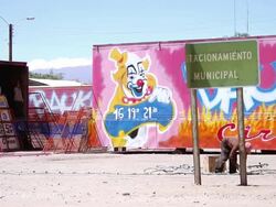 MS Large truck containers with colorful circus decorations with people working and man in ground fixing cable and light bulbs Stock Footage