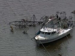 Aerial boat tangled in fallen power lines / pan fallen electrical towers / New Orleans, Louisiana Stock Footage