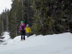 Girl and mother with their baby walking in snow / Whistler, BC, Canada Stock Footage
