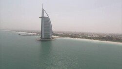 The Burj al-Arab hotel rises above an artificial island in the Persian Gulf. Stock Footage